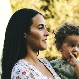 Diane Kuthy, founder of Sandpoint Soda Company, with her child on the family homestead